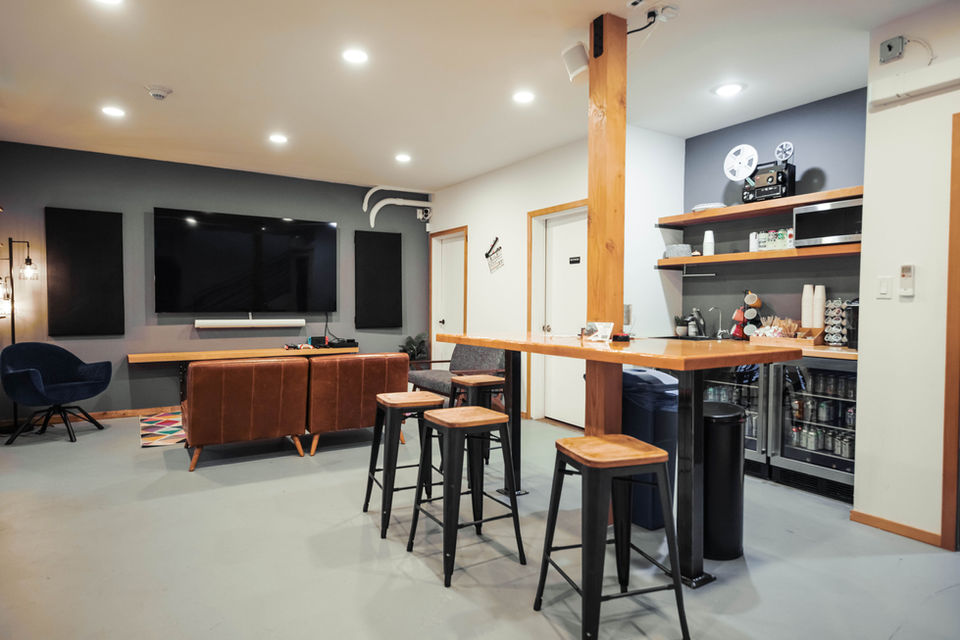 Viewing lounge with seating, high-top table, and monitor