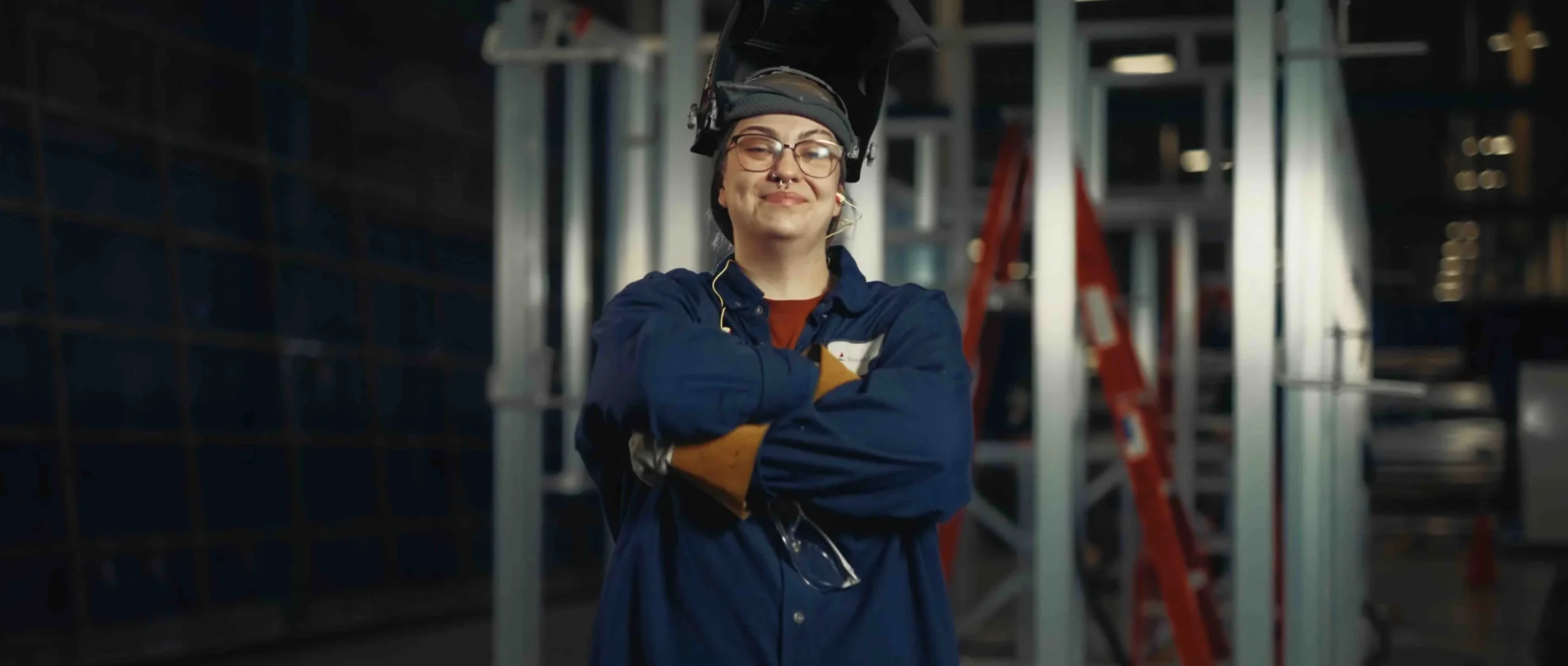 Industrial portrait — welder with arms crossed