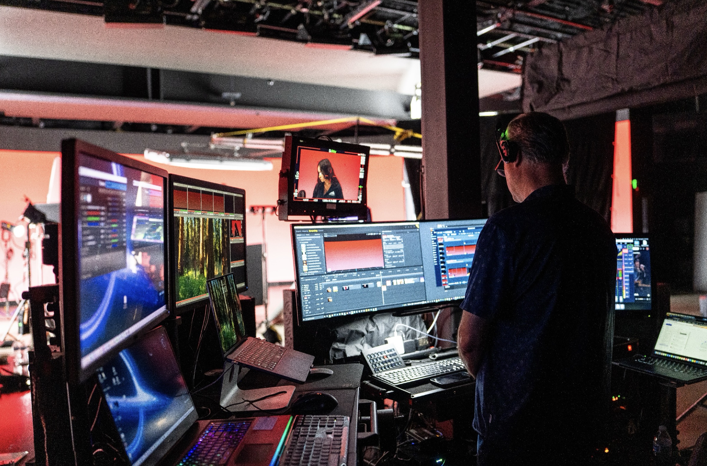 Virtual production technician monitoring Unreal Engine content, live camera feeds, and LED wall management software at workstation during Qualcomm XR shoot