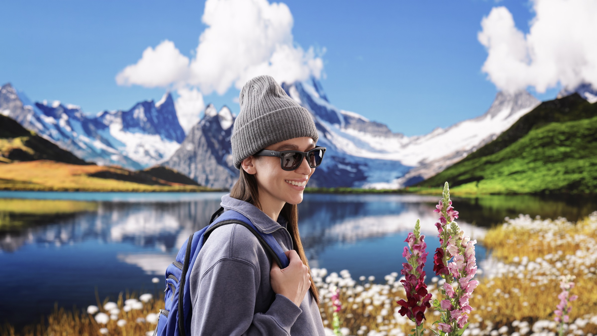 Final camera-ready shot from Qualcomm XR virtual production — model wearing smart XR glasses against LED wall background of snow-covered mountain peaks and turquoise alpine lake