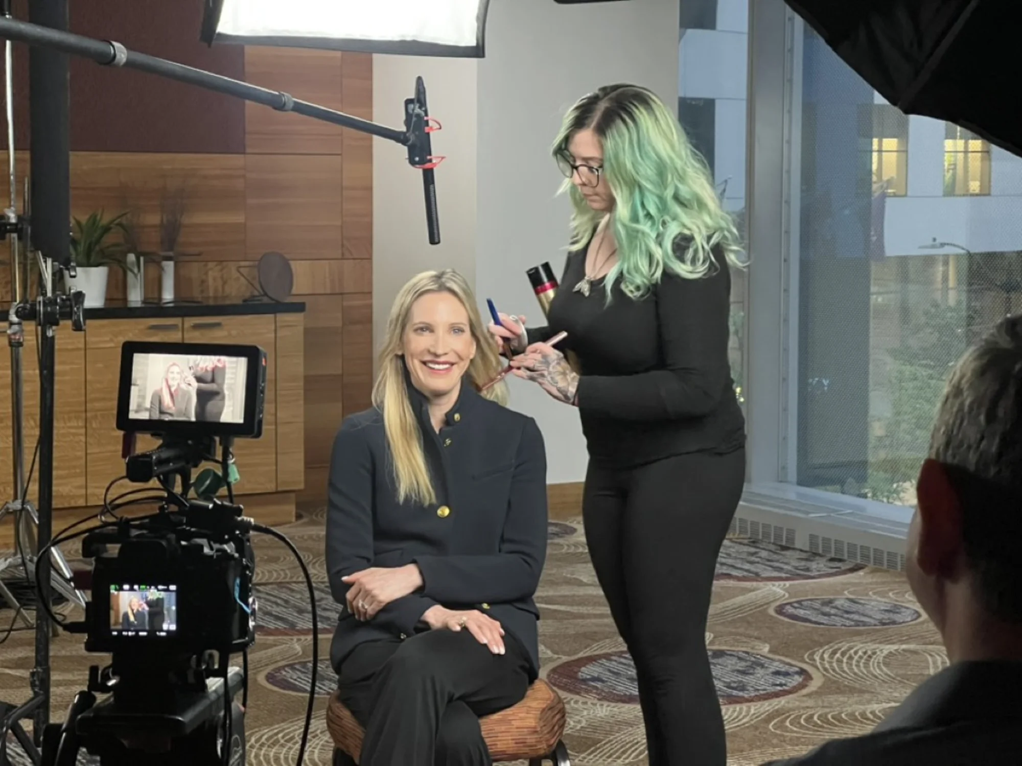 Corporate interview setup with lighting, boom mic, and camera monitor