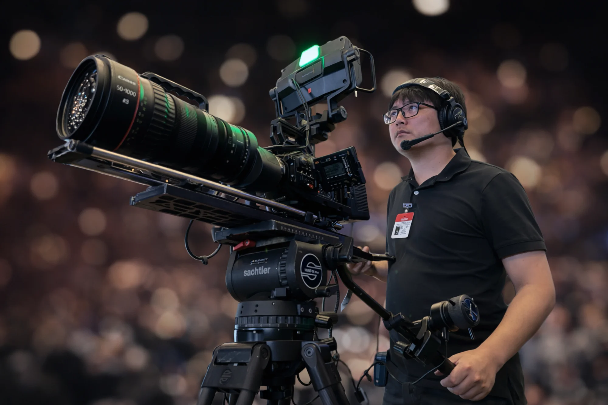 Camera operator capturing speaker sessions at live event