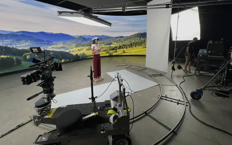 Crew running a camera dolly on a virtual production stage