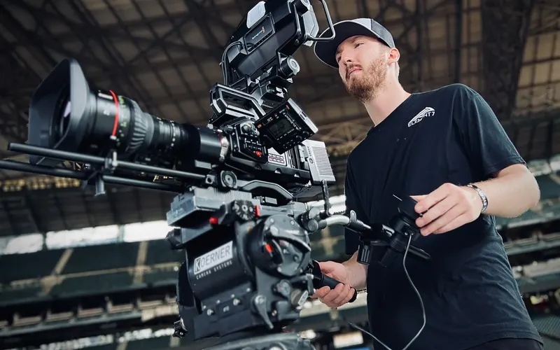 Cinema camera rig with camera operator in a stadium