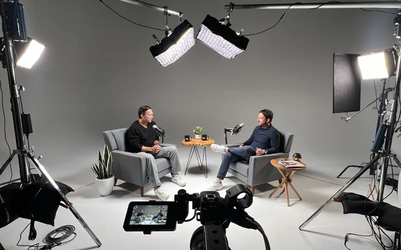 Two-person interview set under the Bothell studio lighting grid