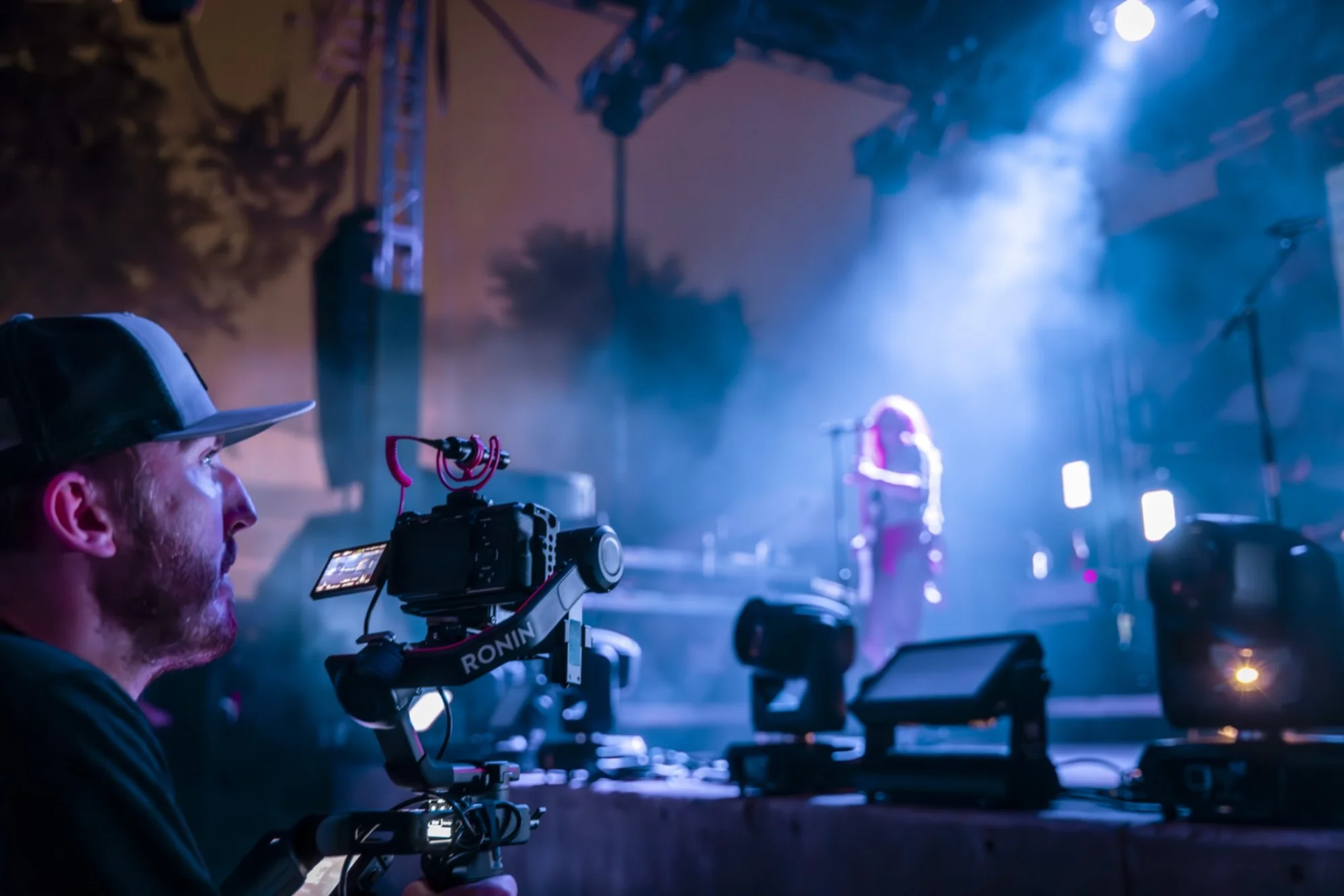 Camera operator with Ronin gimbal filming live concert