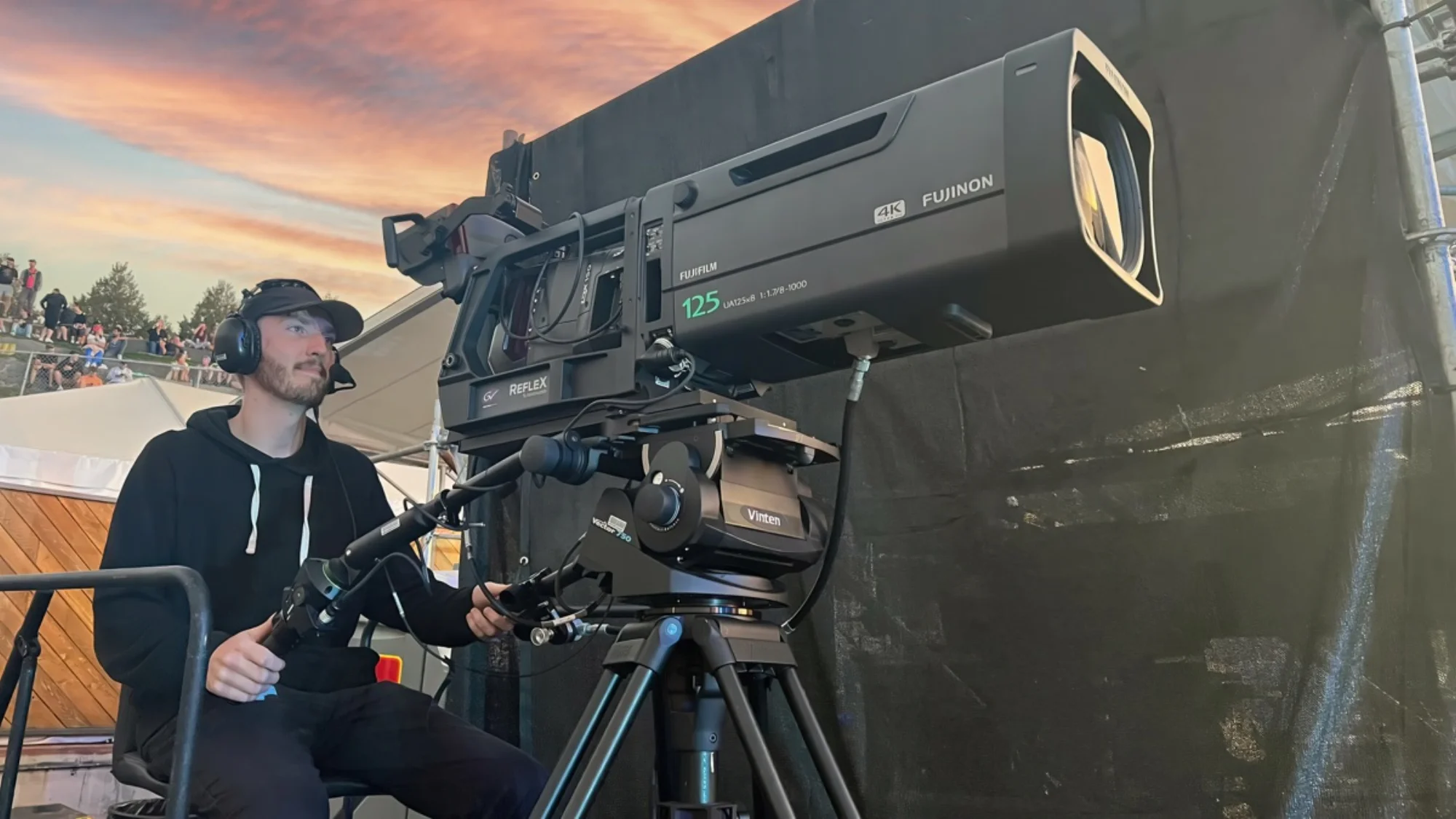 Camera operator with Fujinon 4K box lens at live sports event