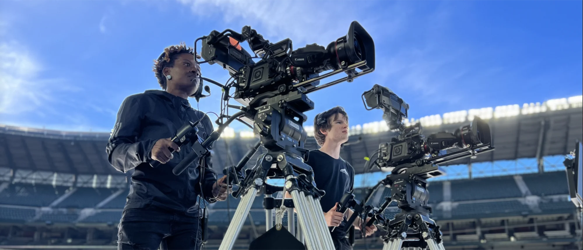 E7 camera operators with broadcast rigs at stadium event