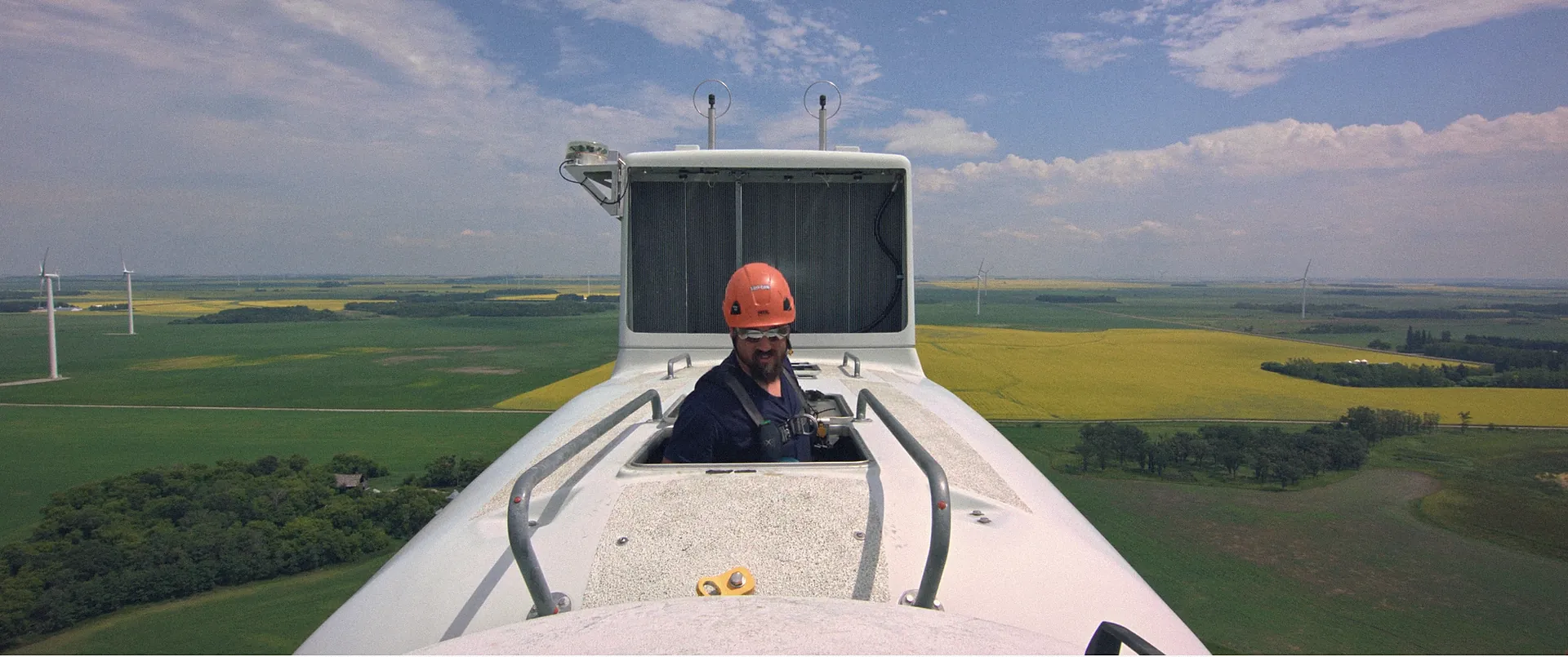 Element 7 crew member at the top of a wind turbine above Washington farmland